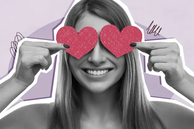 Mujer sonriente sosteniendo corazones de papel frente a sus ojos, simbolizando el tema cómo gustarle a tu crush.