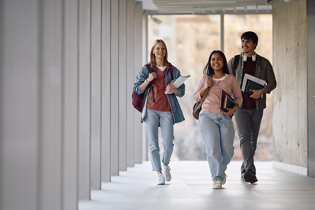 Jóvenes universitarios en su primer día de clases, riendo y conviviendo, simbolizando cómo detectar a futuros amigos en el Día Internacional de la Amistad